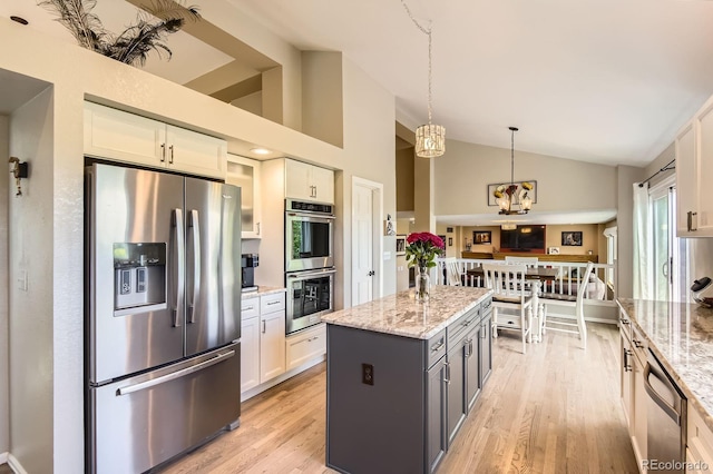 9229 Sugarstone Cir, Highlands Ranch, CO 80130 - kitchen with appliances with stainless steel finishes, light stone countertops, light wood-style flooring, white cabinetry, and hanging light fixtures