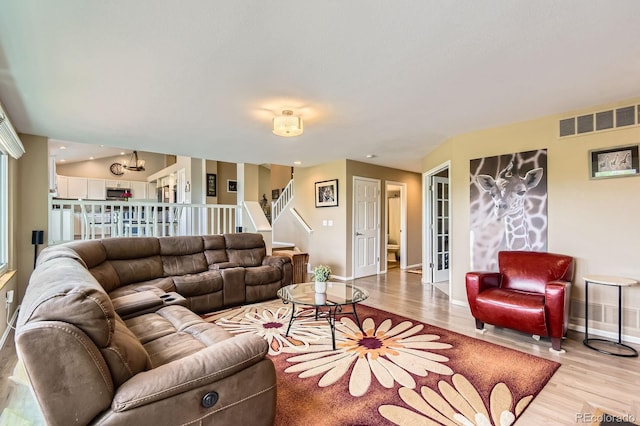 9229 Sugarstone Cir, Highlands Ranch, CO 80130 - living area featuring wood finished floors, baseboards, stairs, and a chandelier