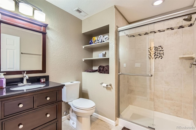 9229 Sugarstone Cir, Highlands Ranch, CO 80130 - full bath featuring toilet, vanity, a shower stall, a textured wall, and tile patterned floors