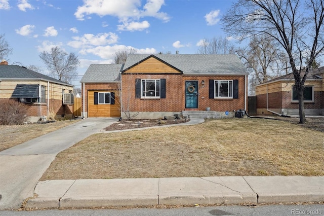 1610 Trenton St, Denver, CO 80220 - bungalow-style house with brick siding, driveway, a front yard, and roof with shingles