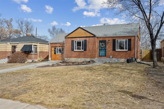 1610 Trenton St, Denver, CO 80220 - bungalow-style home with a front yard, fence, brick siding, and a shingled roof