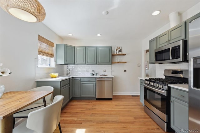 1610 Trenton St, Denver, CO 80220 - kitchen with decorative backsplash, appliances with stainless steel finishes, light countertops, and a sink