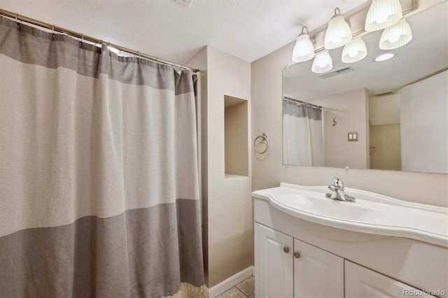1610 Trenton St, Denver, CO 80220 - bathroom with tile patterned floors, visible vents, and vanity