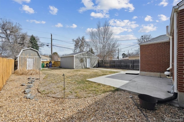 1610 Trenton St, Denver, CO 80220 - view of yard with a patio, a storage unit, a fenced backyard, and an outbuilding
