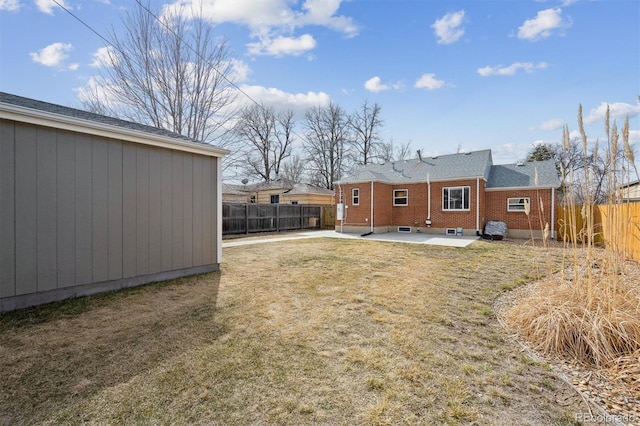 1610 Trenton St, Denver, CO 80220 - back of property with a fenced backyard, a lawn, and a patio