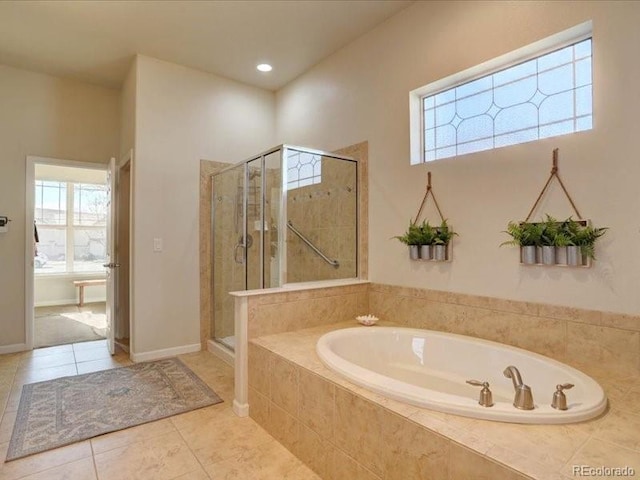 full bath with a stall shower, tile patterned flooring, a wealth of natural light, and a bath