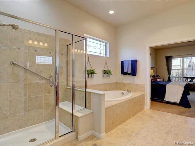 ensuite bathroom with a stall shower, tile patterned flooring, ensuite bath, and a bath