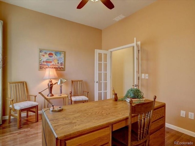 office with visible vents, light wood finished floors, a ceiling fan, and baseboards