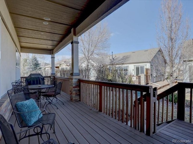 wooden terrace with outdoor dining area