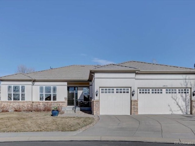 view of front of house with concrete driveway, brick siding, an attached garage, and stucco siding