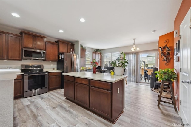 kitchen with appliances with stainless steel finishes, recessed lighting, light countertops, and light wood-style floors