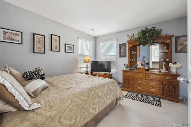 bedroom with visible vents and carpet flooring