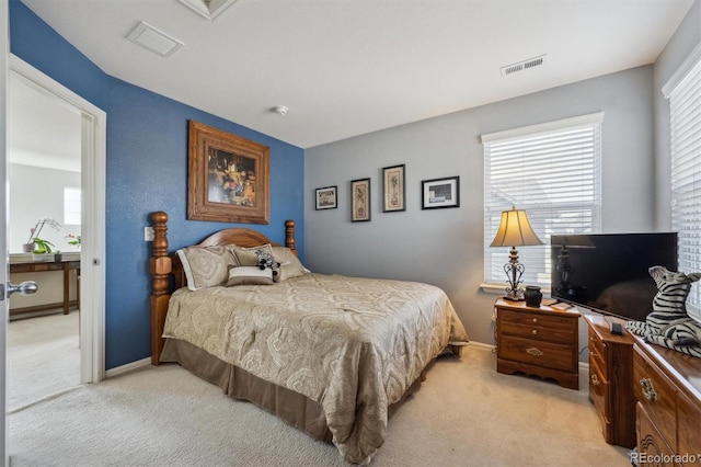 bedroom with light carpet, multiple windows, and visible vents