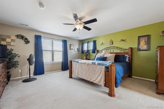 bedroom featuring light colored carpet, visible vents, ceiling fan, and baseboards