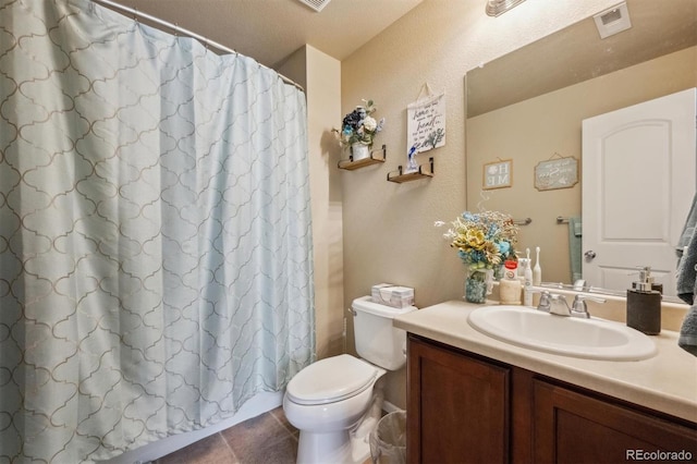 full bathroom featuring a shower with curtain, visible vents, toilet, vanity, and tile patterned flooring