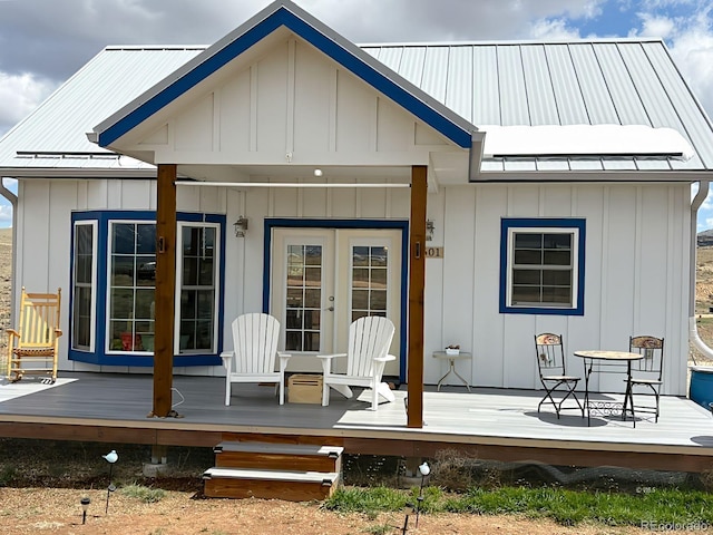 601 N Wood St, Silver Cliff, CO 81252 - back of house featuring board and batten siding, a deck, metal roof, and french doors