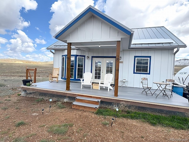 601 N Wood St, Silver Cliff, CO 81252 - back of property featuring board and batten siding, metal roof, french doors, and a standing seam roof