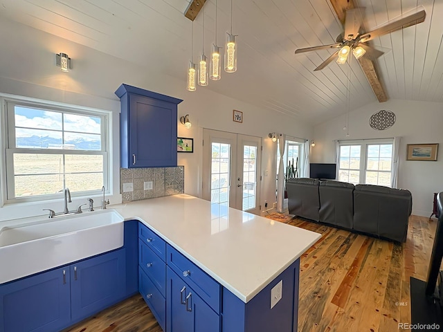 601 N Wood St, Silver Cliff, CO 81252 - kitchen with blue cabinetry, a peninsula, hardwood / wood-style floors, open floor plan, and wooden ceiling
