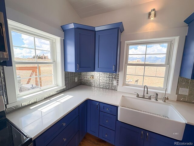 601 N Wood St, Silver Cliff, CO 81252 - kitchen featuring blue cabinetry, a sink, plenty of natural light, and tasteful backsplash