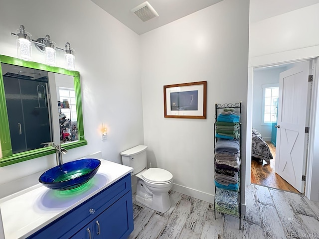 601 N Wood St, Silver Cliff, CO 81252 - bathroom featuring wood finished floors, toilet, vanity, and baseboards