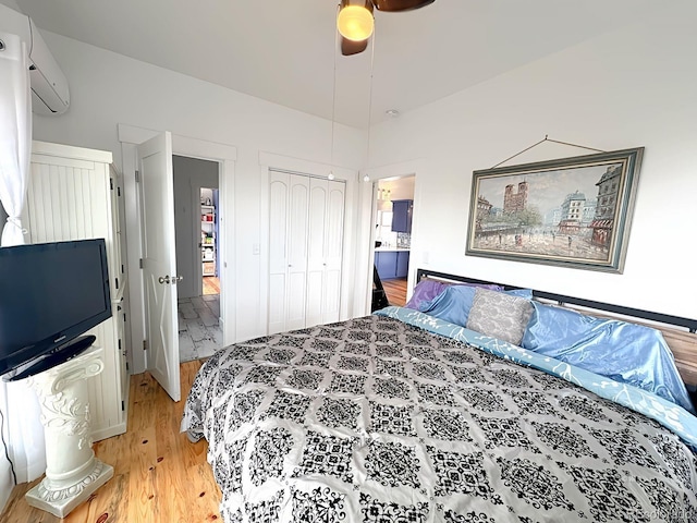 601 N Wood St, Silver Cliff, CO 81252 - bedroom featuring a wall mounted air conditioner, light wood-style flooring, a closet, and a ceiling fan
