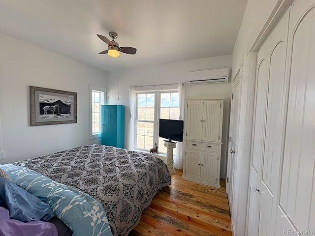 601 N Wood St, Silver Cliff, CO 81252 - bedroom with a wall mounted AC, wood finished floors, and ceiling fan