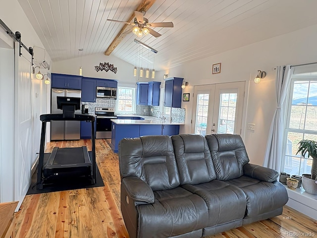 601 N Wood St, Silver Cliff, CO 81252 - living area featuring a barn door, light wood-type flooring, ceiling fan, plenty of natural light, and wood ceiling