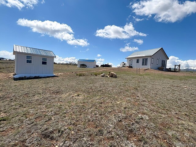 601 N Wood St, Silver Cliff, CO 81252 - view of yard featuring an outbuilding and a view of countryside