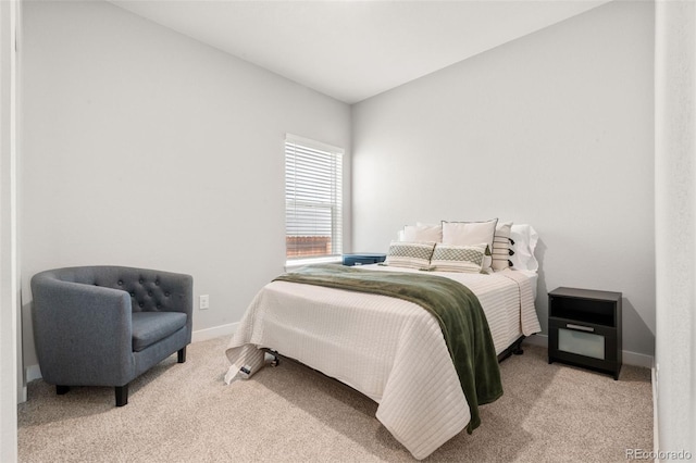 bedroom with light colored carpet and baseboards