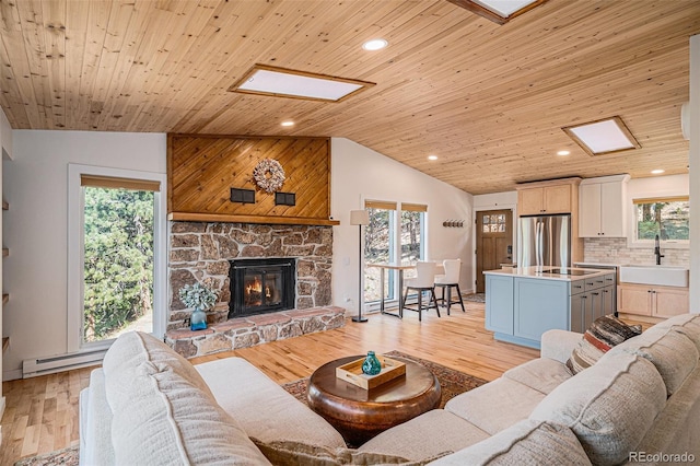 32783 Lodgepole Cir, Evergreen, CO 80439 - living area with vaulted ceiling, wood ceiling, baseboard heating, light wood-type flooring, and recessed lighting