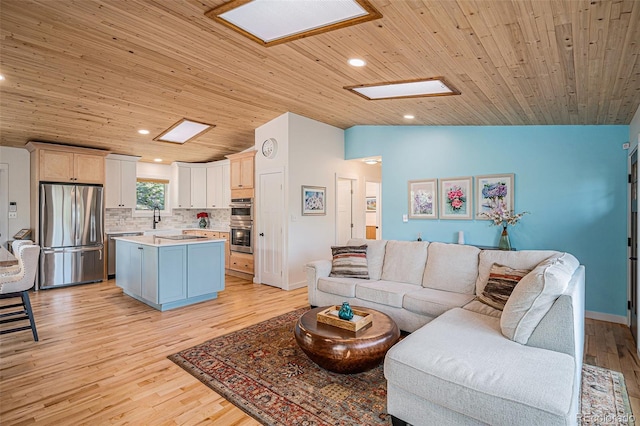 32783 Lodgepole Cir, Evergreen, CO 80439 - living room featuring wooden ceiling, a skylight, lofted ceiling, light wood-style flooring, and recessed lighting