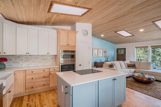 32783 Lodgepole Cir, Evergreen, CO 80439 - kitchen featuring stainless steel appliances, open floor plan, vaulted ceiling, decorative backsplash, and light wood finished floors
