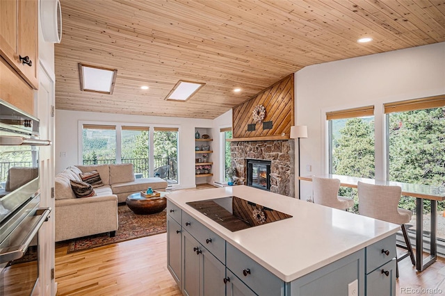 32783 Lodgepole Cir, Evergreen, CO 80439 - kitchen with gray cabinets, open floor plan, double oven, lofted ceiling, and wooden ceiling