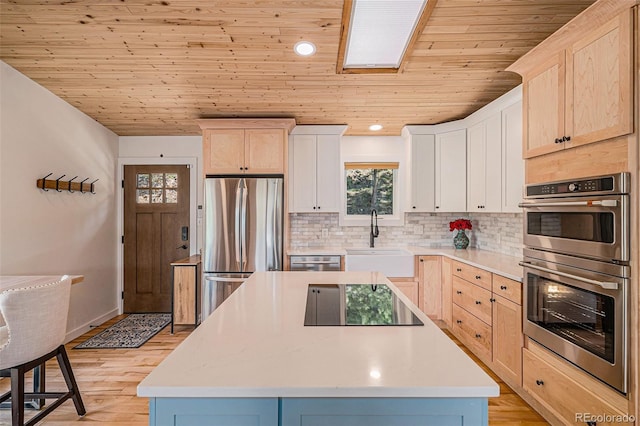 32783 Lodgepole Cir, Evergreen, CO 80439 - kitchen with stainless steel appliances, wooden ceiling, decorative backsplash, light countertops, and light brown cabinets