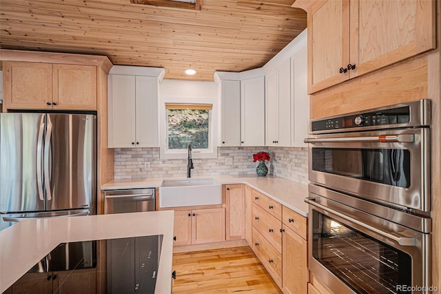 32783 Lodgepole Cir, Evergreen, CO 80439 - kitchen featuring stainless steel appliances, wood ceiling, light countertops, light brown cabinetry, and recessed lighting