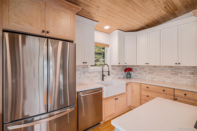 32783 Lodgepole Cir, Evergreen, CO 80439 - kitchen featuring appliances with stainless steel finishes, wooden ceiling, light countertops, tasteful backsplash, and white cabinetry