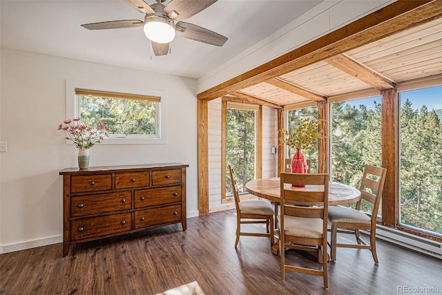 32783 Lodgepole Cir, Evergreen, CO 80439 - dining space with healthy amount of natural light, dark wood-style floors, a ceiling fan, and beamed ceiling