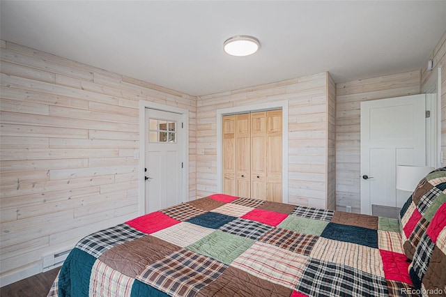 32783 Lodgepole Cir, Evergreen, CO 80439 - bedroom featuring wooden walls, wood finished floors, and a closet