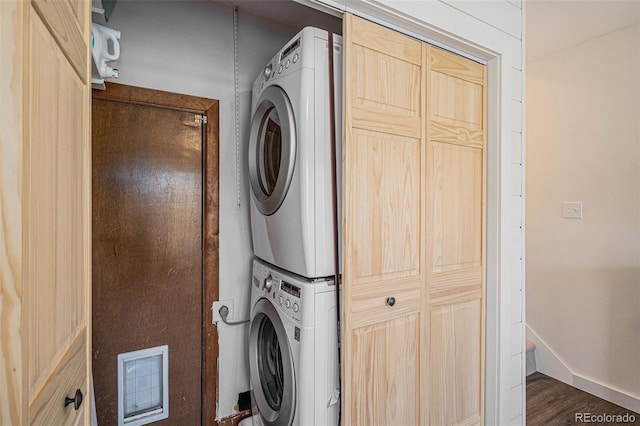32783 Lodgepole Cir, Evergreen, CO 80439 - laundry room with stacked washing machine and dryer and dark wood finished floors