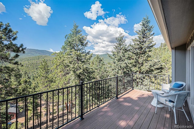 32783 Lodgepole Cir, Evergreen, CO 80439 - wooden terrace featuring a wooded view and a mountain view