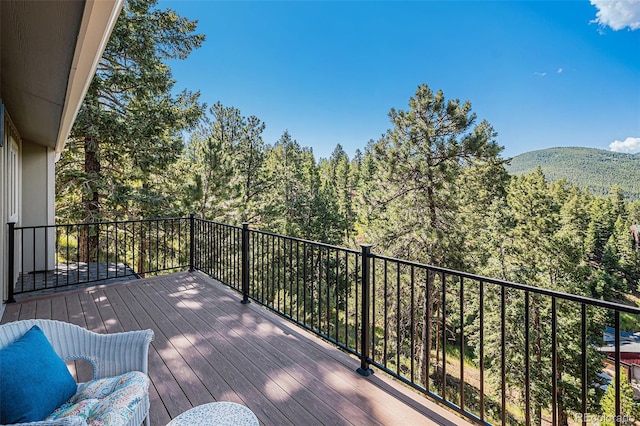32783 Lodgepole Cir, Evergreen, CO 80439 - wooden terrace with a wooded view and a mountain view