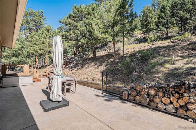 32783 Lodgepole Cir, Evergreen, CO 80439 - view of patio / terrace with outdoor dining space and view of scattered trees