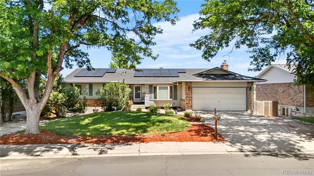 17503 E Lasalle Dr, Aurora, CO 80013 - ranch-style house with brick siding, an attached garage, driveway, a front yard, and solar panels