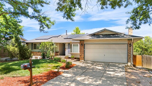 17503 E Lasalle Dr, Aurora, CO 80013 - ranch-style home with brick siding, driveway, a garage, solar panels, and a chimney