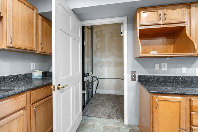 17503 E Lasalle Dr, Aurora, CO 80013 - kitchen featuring dark stone countertops and light tile patterned floors