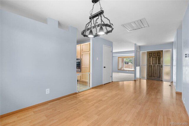 17503 E Lasalle Dr, Aurora, CO 80013 - spare room featuring light wood finished floors and a chandelier