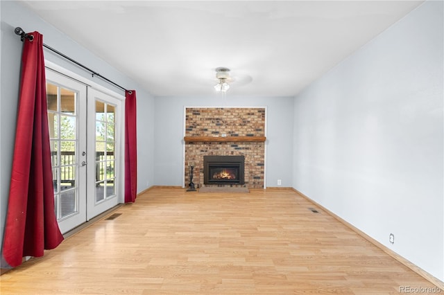 17503 E Lasalle Dr, Aurora, CO 80013 - unfurnished living room featuring french doors, light wood finished floors, and a brick fireplace