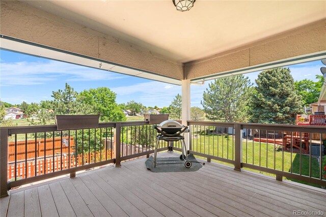 17503 E Lasalle Dr, Aurora, CO 80013 - wooden deck with a lawn and grilling area