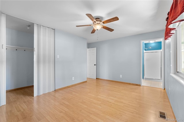 17503 E Lasalle Dr, Aurora, CO 80013 - unfurnished bedroom featuring wood finished floors, a spacious closet, a ceiling fan, and a closet