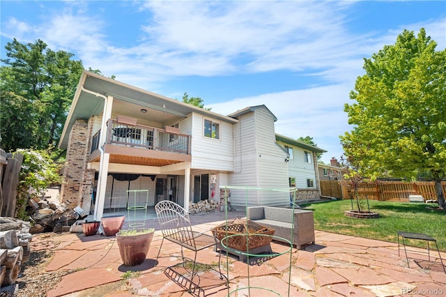 17503 E Lasalle Dr, Aurora, CO 80013 - back of property featuring a balcony, a fire pit, and a patio area